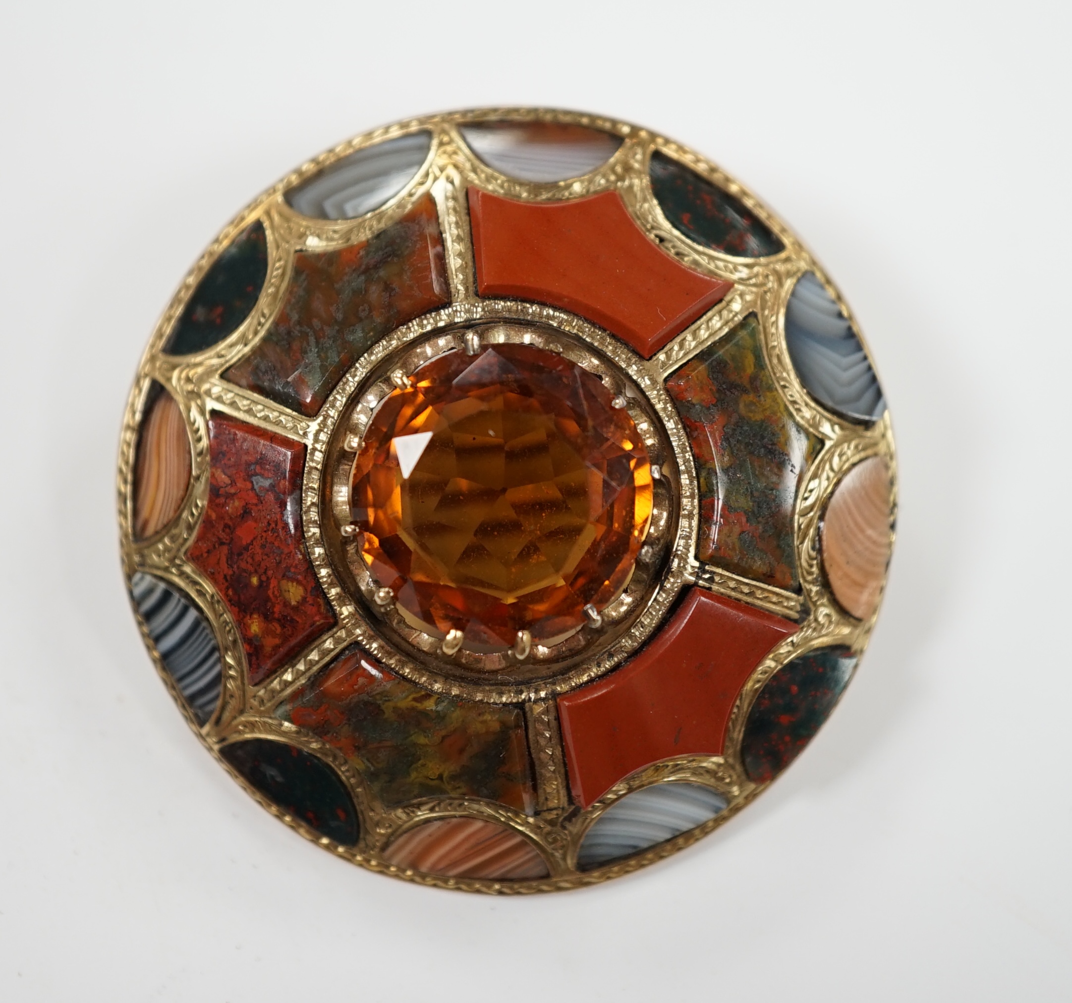A Scottish yellow metal, citrine and Scottish hardstone set circular brooch, 41mm.